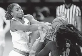  ?? JULIO CORTEZ/AP ?? Maryland guard Diamond Miller, left, competes for a rebound with Minnesota forward Kadiatou Sissoko (30) and center Klarke Sconiers on Saturday.