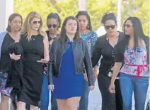  ?? RED HUBER/STAFF PHOTOGRAPH­ER ?? Pulse nightclub owner Barbara Poma, second from left, and others leave the federal courthouse after Friday’s not-guilty verdict for Noor Salman. Poma encouraged survivors to “find peace in our hearts.”