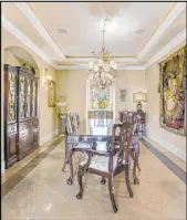 ??  ?? The formal dining room has a French design. The Roma Hills home is listed for $1.69 million.