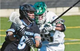  ?? KIM HAIRSTON/BALTIMORE SUN ?? Johns Hopkins’ Brendan Grimes is defended by Loyola Maryland’s Alex Bean during a game at the Ridley Athletic Complex on Feb. 18.