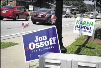  ?? JOHN AMIS / CONTRIBUTE­D ?? Both Republican Karen Handel and Democrat Jon Ossoff have deployed volunteers throughout the 6th District to plant signs and knock on doors.