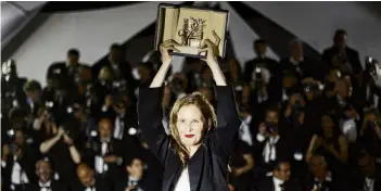  ?? PHOTO: REUTERS ?? Director Justine Triet, Palme d’Or award winner for
the film Anatomy of a Fall, poses after the closing ceremony of the 76th Cannes Film Festival yesterday.