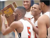  ??  ?? West Side Paris Roberson, left, and guard Quimari Peterson hoist the plaque after winning the Class 4A West Side Sectional title game.