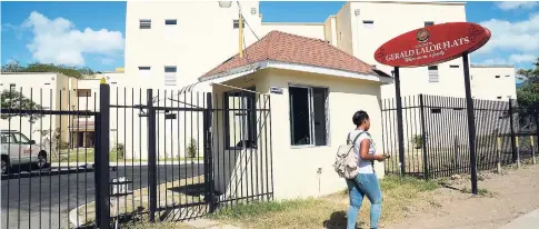  ??  ?? A student walks by a set of student flats developed at UWI Mona by 138 Student Living Jamaaica. UWI and 138 Student Living are partnering on a rental programme for student lodgings left idle during the summer.