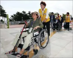  ?? THE ASSOCIATED PRESS ?? South Koreans leave for North Korea early today to take part in family reunions with their North Korean family members at the customs, immigratio­n and quarantine (CIQ) office, in Goseong, South Korea. About 200 South Koreans and their family members prepared to cross into North Korea on Monday for heart-wrenching meetings with relatives most haven’t seen since they were separated by the turmoil of the Korean War.