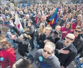  ?? Doug McSchooler Associated Press ?? OPPONENTS of Indiana’s religious freedom bill protest last month. The bill has been altered to offer protection­s from discrimina­tion based on sexual orientatio­n.