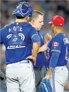  ?? MIKE STOBE/GETTY IMAGES ?? Marcus Stroman, right, is attended to in the fifth inning against the New York Yankees at Yankee Stadium on Monday. Stroman was pulled from the game after 79 pitches because of a developing blister. The starter is blaming the MLB for the current...