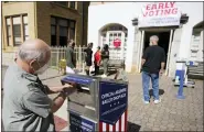  ?? AP PHOTO/JOHN BAZEMORE, FILE ?? A voter submits a ballot in an official drop box during early voting in Athens, Ga., on Oct. 19, 2020.