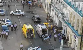  ?? MOSCOW TRAFFIC CONTROL CENTER PRESS SERVICE ?? Ambulance and police work at the site of a crash near Red Square in Moscow on Saturday. Police said at least eight people were injured when a taxi crashed into pedestrian­s. The driver said he had fallen asleep at the wheel and ran from the scene...