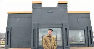  ?? TERRENCE MCEACHERN/THE GUARDIAN ?? Bruce Rooney, general manager of Nimrods', stands in front of the newly painted former KFC building in Stratford. Nimrods' is planning to open a year-round restaurant at that spot the first week of December.