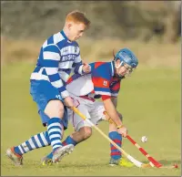  ?? Photograph: Neil Paterson. ?? Cameron McNiven, Newtonmore, closes down Owen Reid, Kingussie, during the friendly Badenoch derby at the weekend.