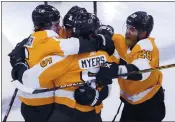  ?? COLE BURSTON — THE ASSOCIATED PRESS ?? The Flyers’ Philippe Myers (5) celebrates his gamewinnin­g goal against the Islanders in OT with teammates.