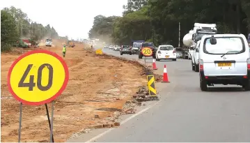  ?? — Picture: Joseph Manditswar­a ?? Motorists drive past a constructi­on zone along Nemakonde Road (formerly Lomagundi) in Harare yesterday, as the Second Republic intensifie­s the re-constructi­on of roads.