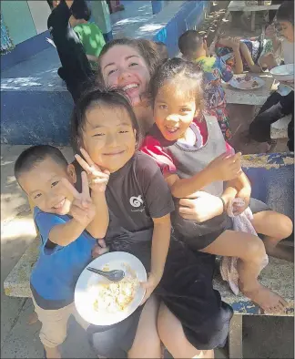  ?? SUBMITTED ?? Claire Keddy poses for a photo with some children at an orphanage in Singburi, Thailand.