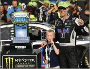  ?? PAUL SANCYA — ASSOCIATED PRESS ?? Kevin Harvick celebrates with his son, Keelan, after winning at Michigan Internatio­nal Speedway on Sunday afternoon.