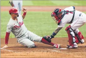  ?? WINSLOW TOWNSON — THE ASSOCIATED PRESS ?? Philadelph­ia Phillies’ Rhys Hoskins slides home safely ahead of the tag by Boston Red Sox catcher Christian Vazquez during the first inning of a baseball game Wednesday, Aug. 19, 2020, at Fenway Park in Boston.