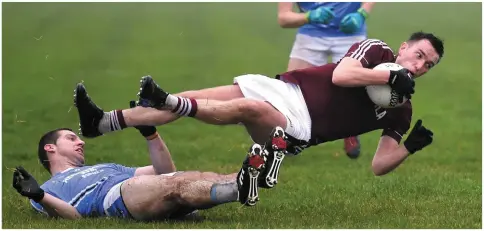  ?? Photo by Michelle Cooper Galvin ?? Dominic O’Sullivan Dromid Pearses flies over Colm O’Shea Firies in the Kerry County Castleisla­nd Co-Op Junior Premier Football Championsh­ip final at JP O’Sullivan Park, Killorglin.