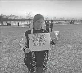  ?? GINA BUTKOVICH / THE COMMERCIAL APPEAL ?? Kimberly Baker holds her sign at the Feb. 5 Tyre Nichols vigil. The Sunset Canopy at the renovated Tom Lee Park has been named in memory of Nichols.