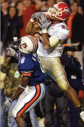  ?? AJC ?? Michael Johnson outjumps Horace Willis for a touchdown reception on fourth-and-15 to give Georgia a 24-21 victory at Auburn in 2002, clinching the SEC East championsh­ip in former coach Mark Richt’s second season with the Bulldogs.