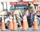  ?? RICH POPE/ORLANDO SENTINEL ?? Members of the 101st Airborne Division of the U.S. Army help an individual get through the line of the new FEMA COVID-19 vaccine site at Valencia College’s west campus on Wednesday.