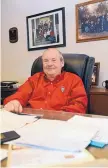  ?? JIM THOMPSON/JOURNAL ?? Howard McCall sits in his office at the company he owns, Capital Realty Inc. On the wall behind him are pictures of his children and grandchild­ren. In addition to his real estate and developmen­t work, McCall is a sought-after auctioneer.