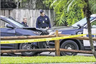  ??  ?? Police examine a Hyundai SUV that reportedly struck two police cars at Palmetto Park on Nathan Hale Road before dawn Monday. Leonardo Anthony Matos, 20, who police shot, faces charges in the case.