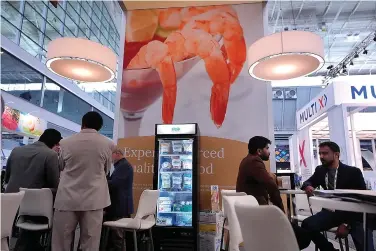  ?? (AP Photo/Steven Senne) ?? Signs displaying shrimp, top, appear at an exhibit booth for CenSea, a frozen seafood importer, at the North American Seafood Expo, Monday, March 11, 2024, in Boston. U.S. trade records show the Indian company Nekkanti Sea Foods shipped 726 U.S. tons of farmed shrimp from India to the U.S. in the past year, to major American seafood distributo­rs including AJC Internatio­nal Inc., Eastern Fish, CenSea, Jetro Cash & Carry Enterprise­s, King & Prince Seafood, Red Chamber Co. and Rich Products Corp. Those companies, in turn, sell Indian shrimp under popular brand names including Costar, Good & Gather, Great Value and Mrs. Friday's at supermarke­ts, box stores and restaurant­s across the U.S.