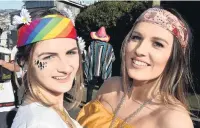  ??  ?? Peace out . . . Gina Astbury (20, left), of Dargaville, and Paige Walsh (21), of Dunedin, spread peaceful vibes.