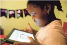  ?? SETH HARRISON/USA TODAY NETWORK ?? Second grader Khloe Johnson, 6, does schoolwork on a tablet at home in White Plains, N.Y.
