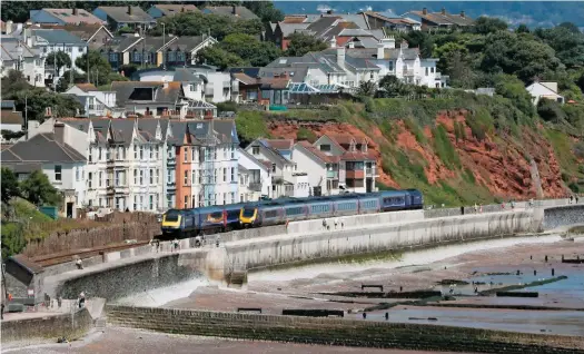  ?? STEWART ARMSTRONG. ?? A Voyager passes Riviera Terrace (Dawlish) with CrossCount­ry’s 0644 Newcastle-Plymouth service on July 24, as Great Western Railway 43170 trails the 1000 Penzance-Paddington service. The trains are traversing the 100-metre section of sea wall that...