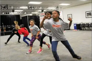  ?? MICHILEA PATTERSON — DIGITAL FIRST MEDIA ?? Young girls participat­e in a fitness routine at the Montgomery County Community College campus in Pottstown as part of an all-girl health and wellness summit.