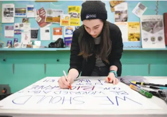  ?? Michael Short / Special to The Chronicle ?? Maya Segal, 15, one of the students scheduled to speak at Saturday’s San Francisco rally and march from the Civic Center to the Embarcader­o, works on her anti-gun-violence sign.