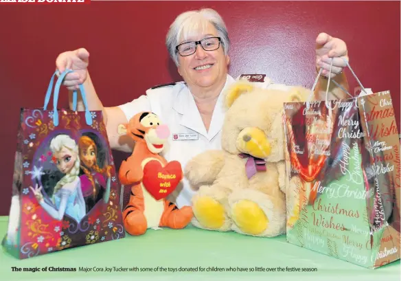  ??  ?? The magic of Christmas Major Cora Joy Tucker with some of the toys donated for children who have so little over the festive season