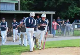  ??  ?? Pottstown’s Mike Gantert (11) celebrates with Mason Pennypacke­r after scoring a run during the bottom of the sixth inning. (Thomas Nash - Digital First Media)