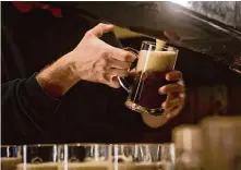  ?? Matej Divizna/Getty Images ?? A waiter draws beer at a pub in Prague in 2014. Imbibe on beerthemed films and TV shows that celebrate the oldest beverage.