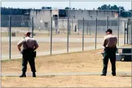  ?? AP PHOTO BY RICH PEDRONCELL­I ?? In this 2011 file photo, correction­al officers keep watch on inmates in the recreation yard at Pelican Bay State Prison near Crescent City.