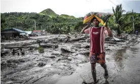  ?? Photograph: Ferdinandh Cabrera/AFP/Getty Images ?? Dozens are feared dead in the village of Kusiong in the southern Philippine­s after it was hit by a mudslide during tropical storm Nalgae.