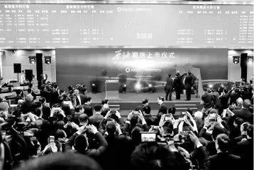  ?? — Reuters photo ?? People attend the launch ceremony of Shanghai crude oil futures at the Shanghai Internatio­nal Energy Exchange in Shanghai, China.The launch of China’s first crude futures contract in Shanghai has added a long-awaited Asian benchmark to the global oil sector, challengin­g the dominance of Western price-markers and threatenin­g ramificati­ons far beyond the energy industry.