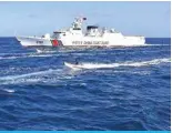  ?? AFP ?? past a Chinese coast guard ship near the China-controlled Scarboroug­h Shoal, in disputed waters of the South China Sea, on February 16, 2024. —