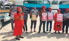  ?? Reuters ?? Campaigner­s hold banners against martial law and the killing of indigenous people in Mindanao island at a protest outside the military headquarte­rs in Quezon City, Philippine­s.