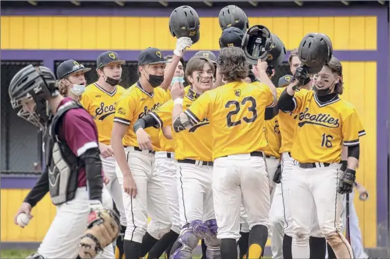  ?? Photos by James Franco / Special to the Times Union ?? The Ballston Spa baseball team greets shortstop Chance Checca (23) after he hit a grand slam in the second inning to give the Scotties a 7-1 lead over Colonie at Ballston Spa High School on Saturday afternoon. Checca later recorded the final out on a forceout at second in the seventh inning.