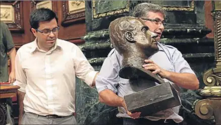  ?? JORDI PLAY / ARCHIVO ?? Un ordenanza retira el busto del rey acompañado del primer teniente de alcalde, Gerard Pisarello, en junio