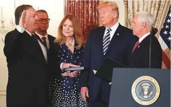  ?? Reuters ?? US Secretary of State Mike Pompeo is sworn in by Vice-President Mike Pence (right) as President Donald Trump and Susan Pompeo look on in Washington, D.C. yesterday.