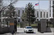  ?? CHIP SOMODEVILL­A / GETTY IMAGES ?? A vehicle exits the embassy of the Russian Federation on Monday in Washington. The U.S. is expelling 60 Russian intelligen­ce officers and ordered the Russians to close their consulate in Seattle.