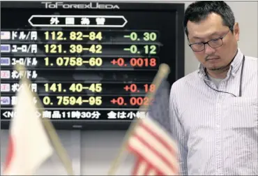  ?? PHOTO: EPA ?? A money dealer takes a moment during a morning trade session in Tokyo on Tuesday, after US President Donald Trump’s formal withdrawal from the Trans-Pacific Partnershi­p. Japan’s strong trade data gave a boost to internatio­nal markets.