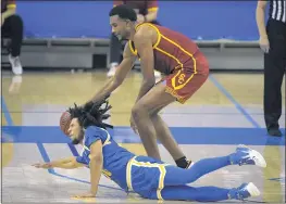  ?? MARK J. TERRILL — THE ASSOCIATED PRESS ?? UCLA’s Tyger Campbell dives for a loose ball as USC’s Evan Mobley corrals it the second half Saturday at Pauley Pavilion. USC won 64-63 to keep its conference title hopes alive.