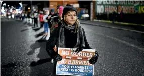  ?? PHOTO: GETTY IMAGES ?? Sinn Fein protesters hold an anti-Brexit white line rally on December 6, 2017 in Belfast, Northern Ireland. Northern Ireland is the only part of the UK which has a land border with the rest of the European Union.