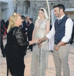  ??  ?? The President with designer James Dimech and model Maria Ellul