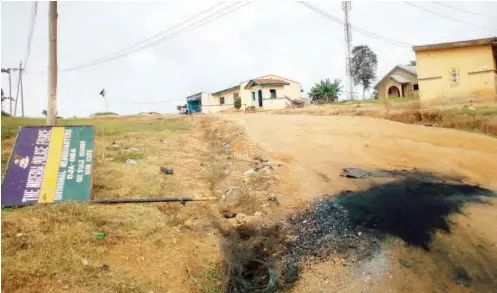  ??  ?? The destroyed sign post of the Oja Oba Police Station