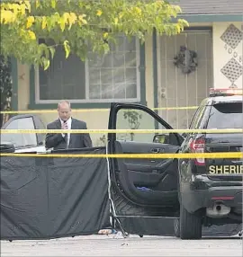  ?? Rich Pedroncell­i Associated Press ?? CRIME SCENE TAPE surrounds the scene of a fatal shooting of a man who was said to be holding a pitchfork while advancing at a sheriff ’s deputy in Sacramento.